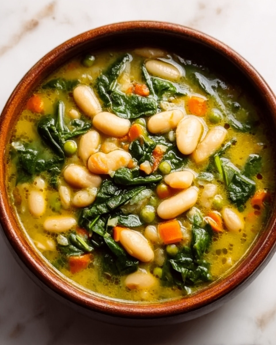 A brown bowl filled with a thick soup shows several layers of ingredients. At the bottom, there is a green leafy layer of cooked spinach spread evenly. Above that, soft white beans with a smooth texture are scattered throughout the soup. Tiny pieces of orange carrot and green peas add small colorful spots in the middle. The soup broth is yellowish and slightly oily, filling the spaces between the solid ingredients. The bowl rests on a white marbled surface. Photo taken with an iphone --ar 4:5 --v 7