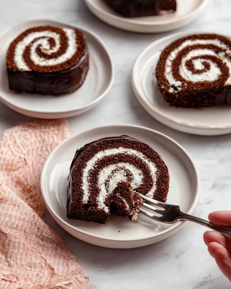 The image shows four slices of chocolate Swiss roll cake on white plates. Each slice has two main visible layers: a rich, dark brown chocolate sponge cake rolled with a thick, creamy white filling spiraled in the center, and a shiny dark chocolate coating around the outside edges. One slice in the foreground has a woman's hand holding a fork that cuts into the cake, showing the soft texture and cream inside. The plates are placed on a white marbled surface, and a light pink cloth napkin is seen in the corner. photo taken with an iphone --ar 4:5 --v 7